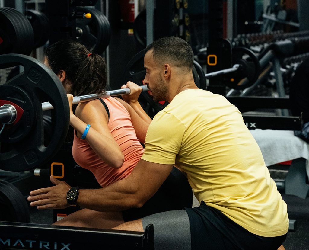 Mujer realizando entrenamiento de fuerza con peso libre en Cosmofit Barcelona.